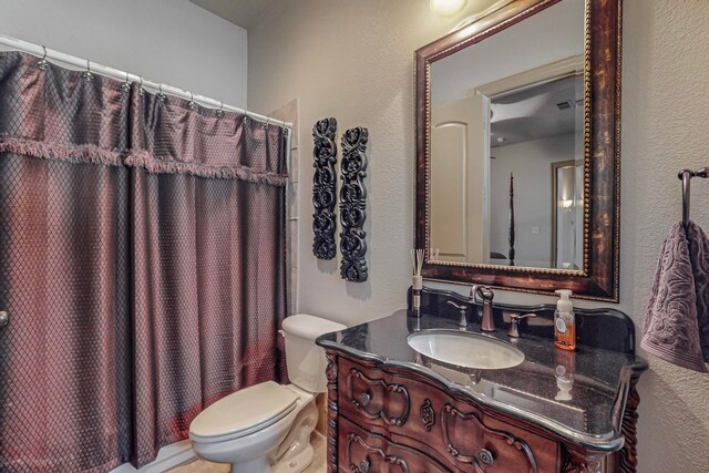 bathroom with vanity, toilet, and a shower with curtain