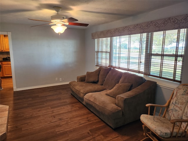 living room with ceiling fan and dark hardwood / wood-style flooring