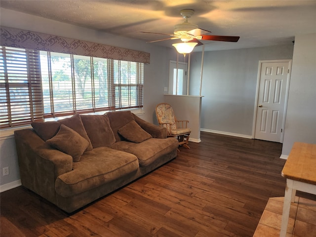 living room with ceiling fan and dark hardwood / wood-style floors