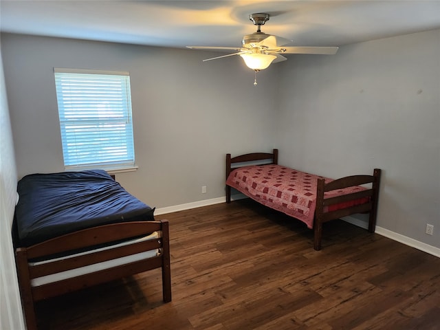 bedroom featuring ceiling fan and dark wood-type flooring