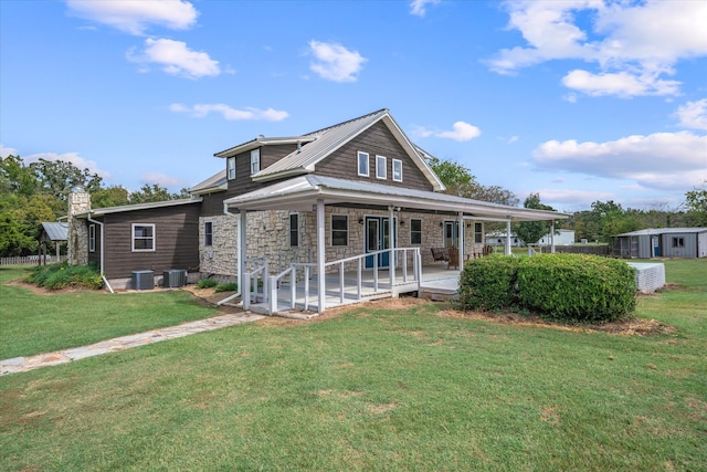 rear view of house featuring a storage shed, a yard, central air condition unit, and a patio area