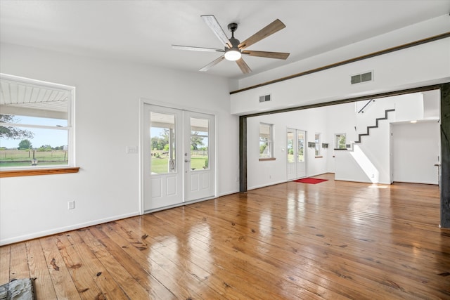 unfurnished living room with wood-type flooring and ceiling fan