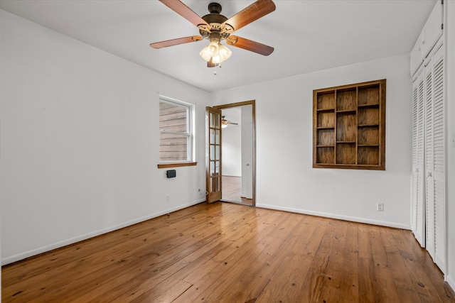 unfurnished bedroom featuring ceiling fan, light wood-type flooring, and a closet