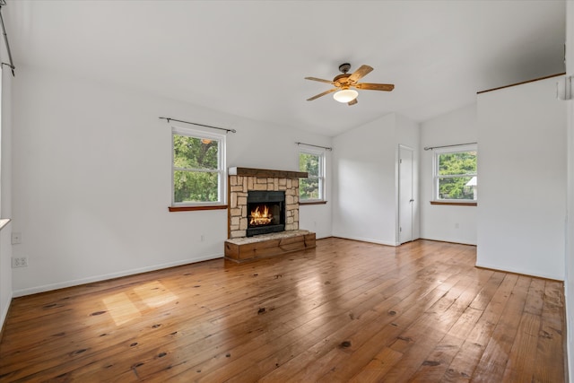 unfurnished living room with a healthy amount of sunlight, a fireplace, hardwood / wood-style floors, and ceiling fan