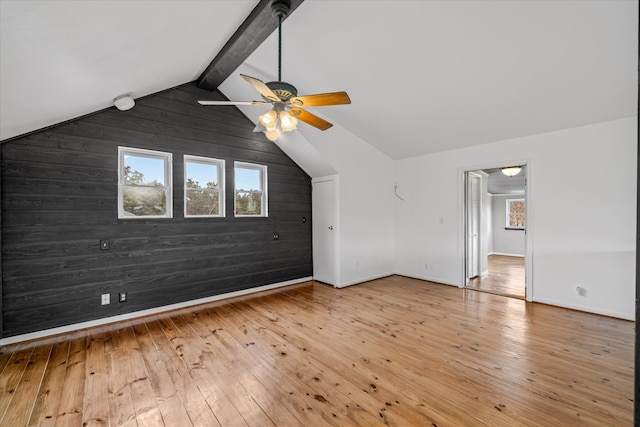 bonus room featuring ceiling fan, vaulted ceiling with beams, wooden walls, and hardwood / wood-style floors