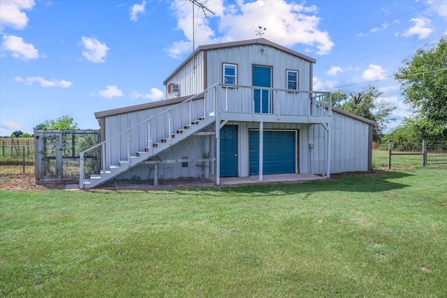 rear view of property featuring a yard and a garage