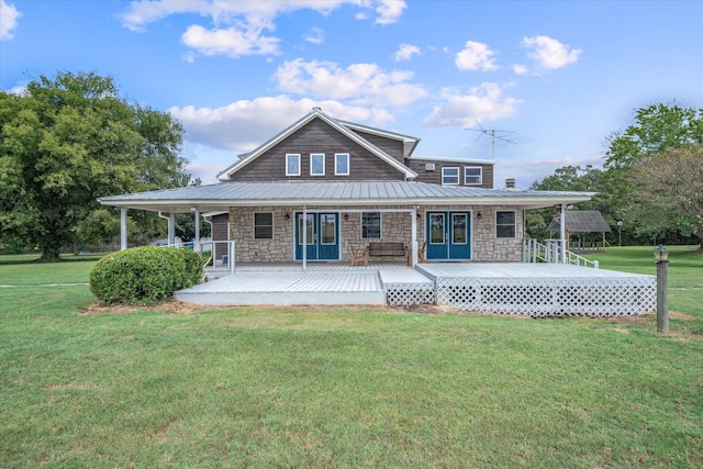 rear view of property featuring a lawn