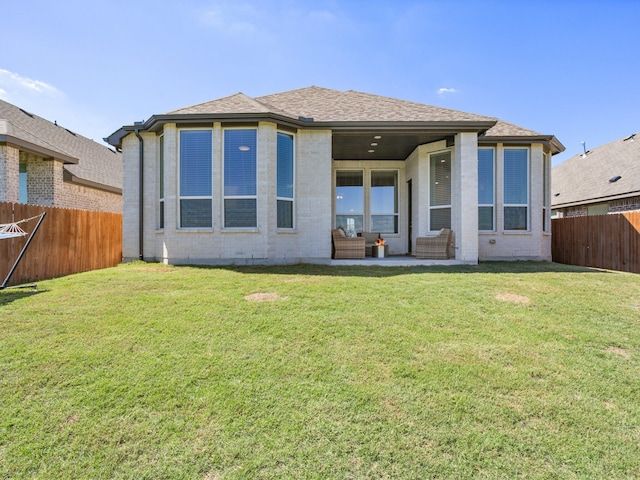 rear view of house featuring a lawn and an outdoor living space