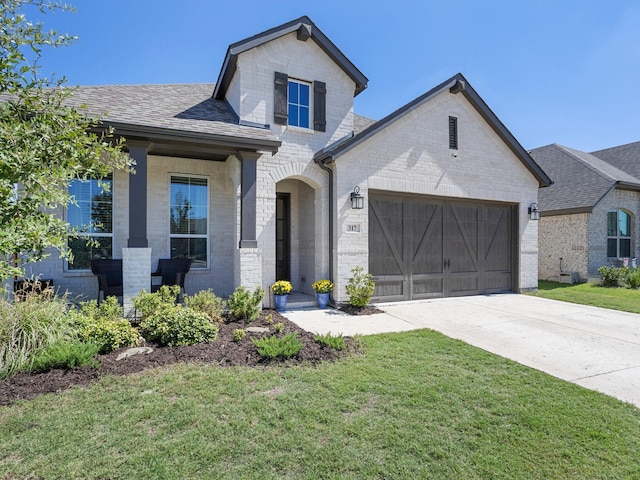 view of front of home with a garage and a front lawn