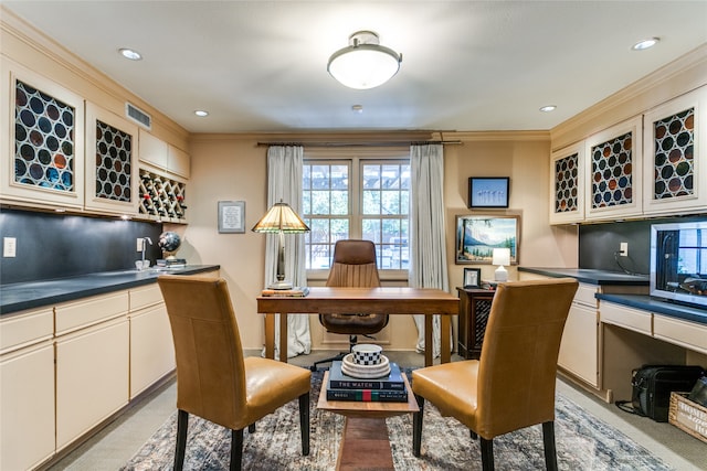 office space featuring built in desk and ornamental molding