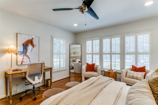 bedroom featuring crown molding, dark wood-type flooring, and ceiling fan