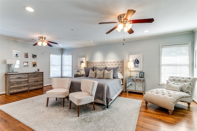 bedroom featuring crown molding, hardwood / wood-style floors, and ceiling fan