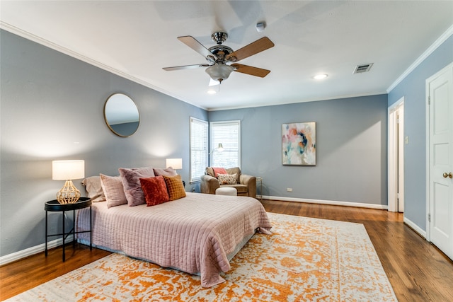 bedroom featuring crown molding, dark wood-type flooring, and ceiling fan