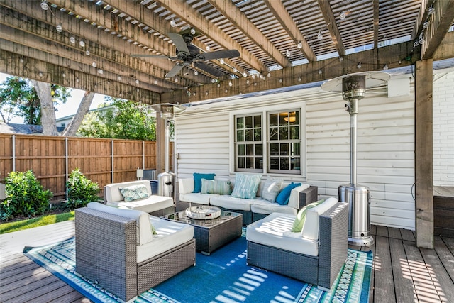 wooden deck featuring an outdoor hangout area, a pergola, and ceiling fan