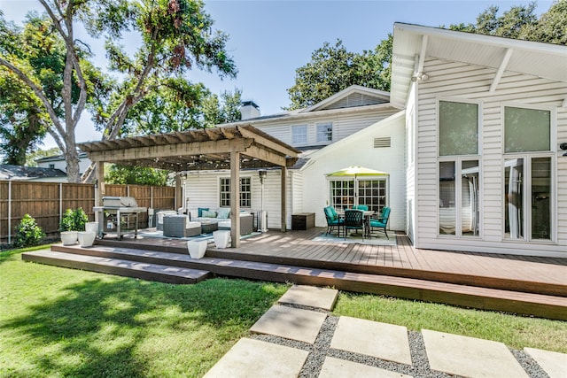 rear view of property with a yard, a pergola, outdoor lounge area, and a wooden deck