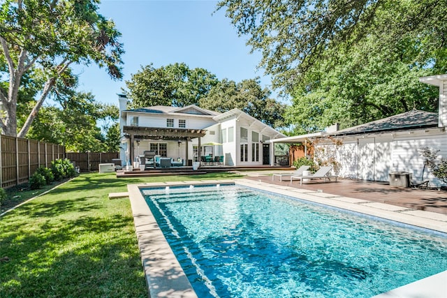 view of pool featuring a wooden deck, a pergola, and a lawn