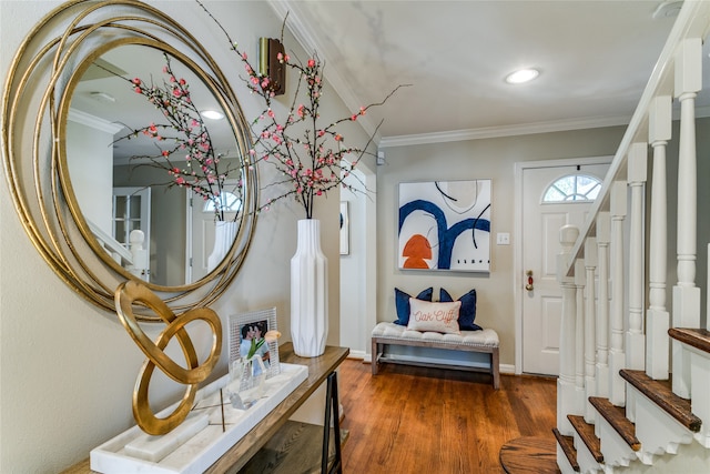 foyer entrance with crown molding and dark hardwood / wood-style floors