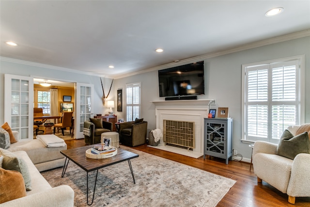 living room featuring crown molding and hardwood / wood-style floors