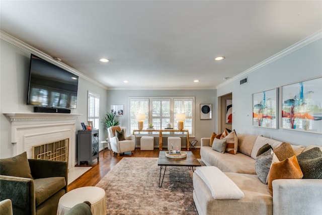 living room with crown molding and hardwood / wood-style floors