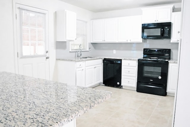 kitchen featuring light tile patterned flooring, sink, white cabinetry, kitchen peninsula, and black appliances