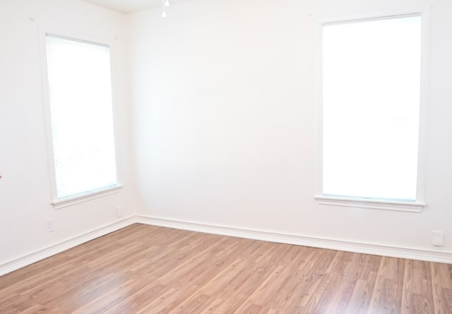 unfurnished room featuring light hardwood / wood-style floors