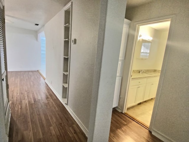 hall featuring sink and dark hardwood / wood-style flooring