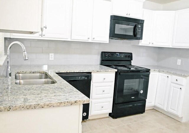 kitchen with white cabinets, black appliances, tasteful backsplash, and sink