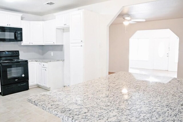 kitchen with white cabinets, sink, and black appliances