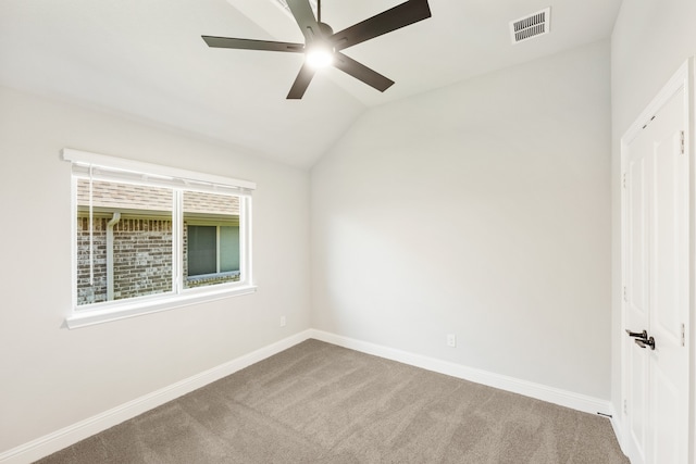 carpeted empty room featuring ceiling fan and vaulted ceiling