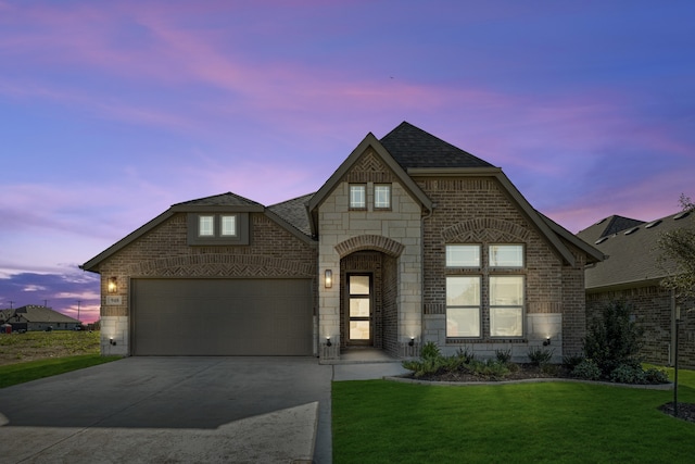 french country home with a lawn and a garage