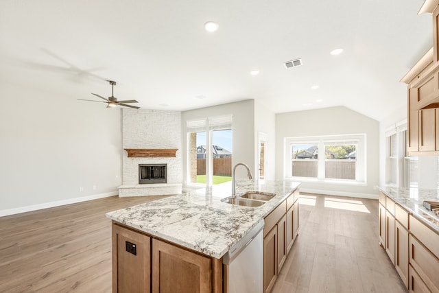 kitchen featuring dishwasher, a healthy amount of sunlight, light wood-type flooring, and sink