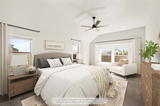 bedroom featuring multiple windows, ceiling fan, dark carpet, and vaulted ceiling