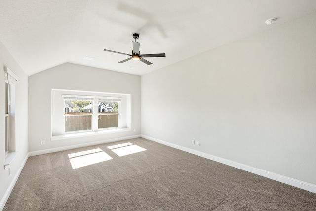 unfurnished room featuring ceiling fan, carpet floors, and vaulted ceiling