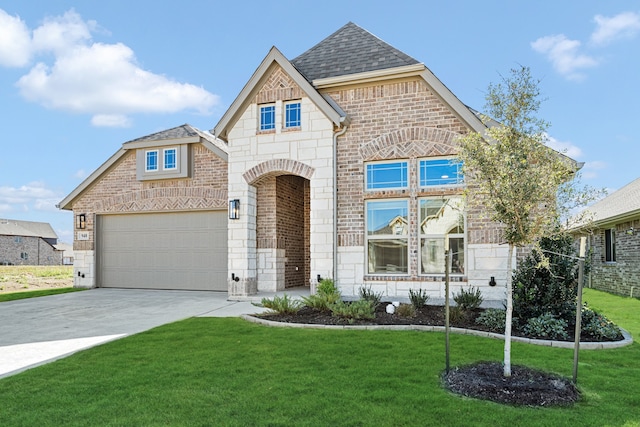 view of front of house featuring a garage and a front lawn