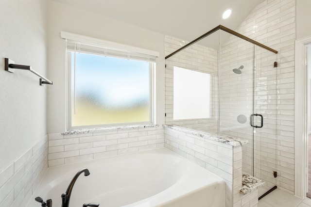 bathroom featuring plenty of natural light, lofted ceiling, and shower with separate bathtub