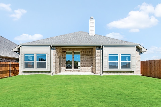 back of house featuring a lawn