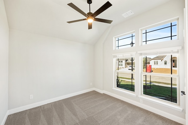 carpeted spare room featuring ceiling fan and high vaulted ceiling