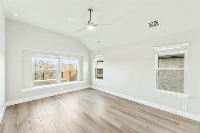 spare room featuring ceiling fan, light hardwood / wood-style flooring, and lofted ceiling