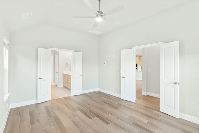 unfurnished bedroom with ceiling fan, light wood-type flooring, and connected bathroom