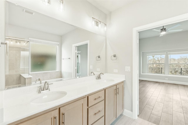 bathroom featuring ceiling fan, a shower with shower door, and vanity