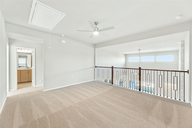 carpeted spare room with ceiling fan