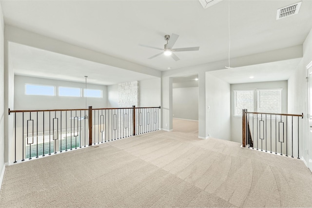 carpeted spare room featuring ceiling fan