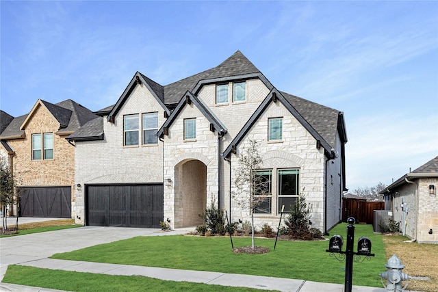 view of front of home featuring a front lawn and a garage