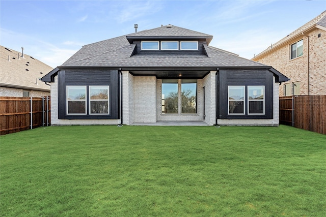 back of house featuring a patio and a lawn