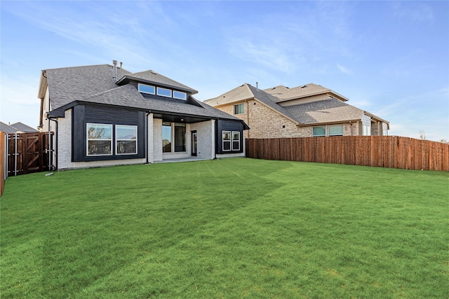 back of house featuring a yard