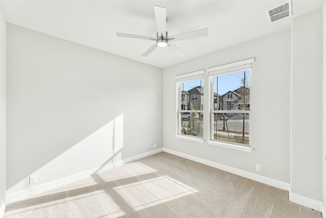 empty room featuring carpet floors and ceiling fan