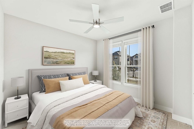 bedroom with ceiling fan and light colored carpet