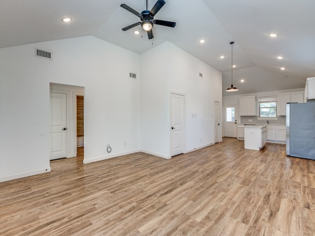 unfurnished living room featuring ceiling fan, light hardwood / wood-style floors, and high vaulted ceiling