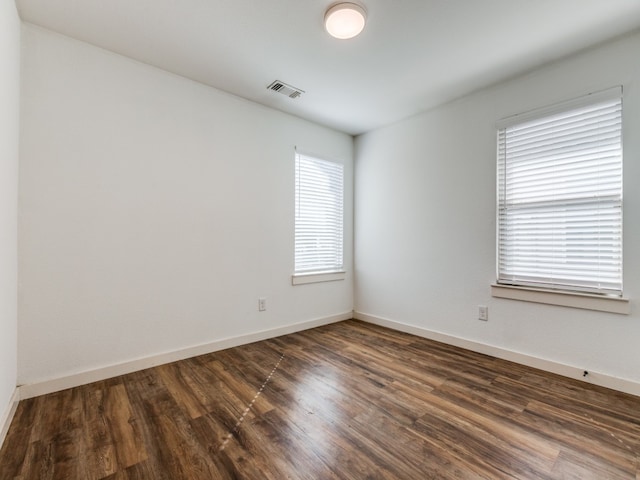 unfurnished room featuring dark wood-type flooring