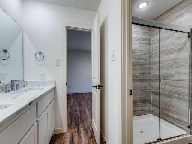 bathroom featuring vanity, hardwood / wood-style flooring, and walk in shower